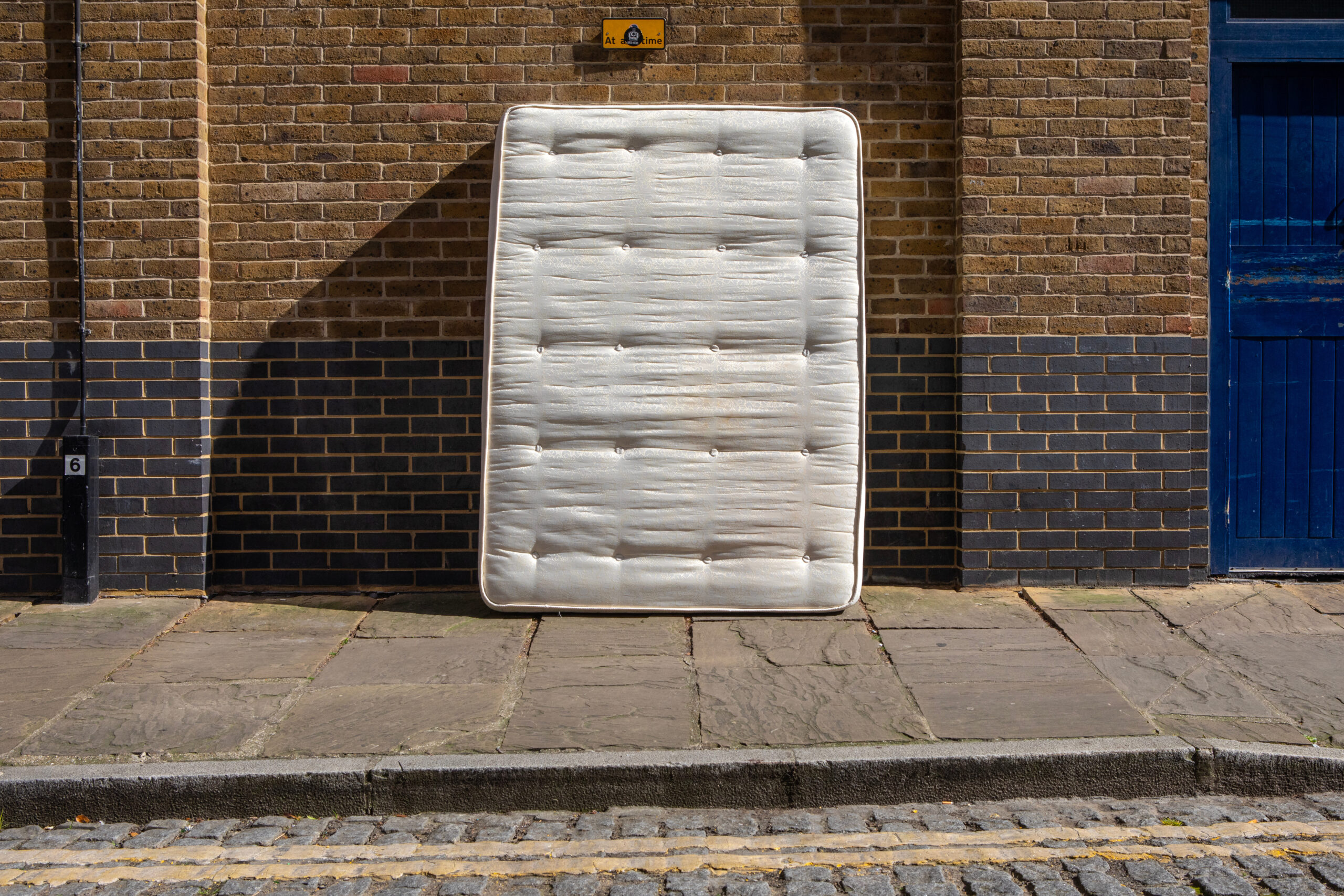abandoned mattress on the curb