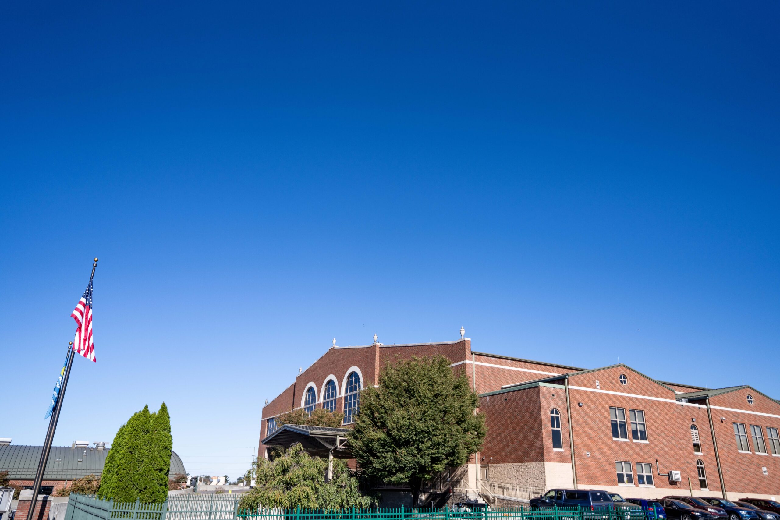 Side view of LCSWMA's Transfer Station and a flagpole with the American Flag
